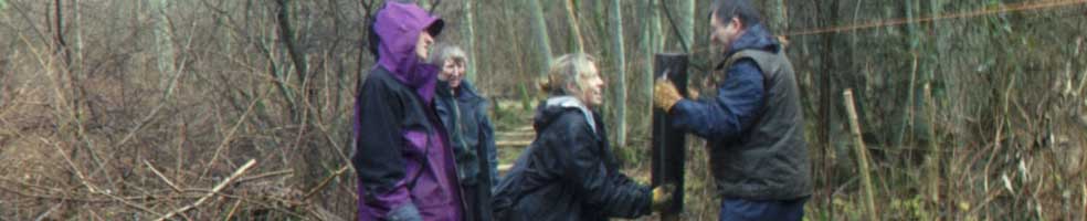 Ramming in a fence post in Gamlingay Wood.