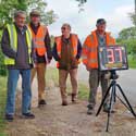 The Hatley Speedwatch team of (l to r) Peter Gouldson, Alan Pinney, Martin Ward and team leader Harold Nickerson, May 2023. They are by Hatley Main Street where the speed limit is currently 40 mph.